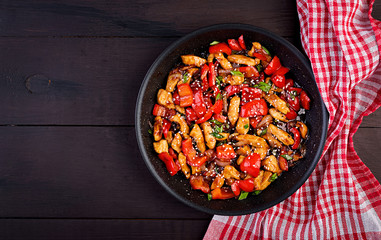Stir fry chicken, sweet peppers and green onion. Top view. Asian cuisine