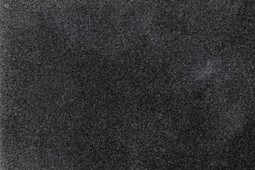 Fototapeta premium Black canvas or velvet paper texture. Closeup
