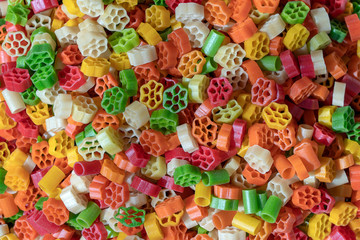 Colorful food macaroni pasta background in market for sale, India, close up