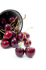 White cup with red sweet cherry isolated on a white background..