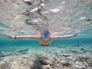 Woman snorkeling close to coral reef, Red Sea, Egypt