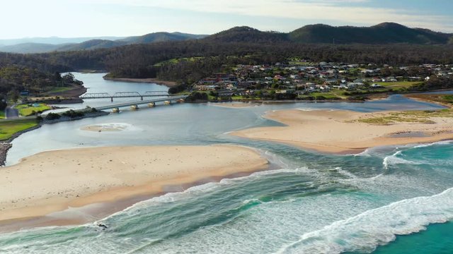 Areal drone shot of the river estuary bridges banks ocean shore at Scamander Tasmania