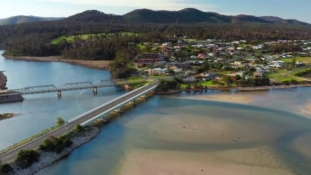 Fly away areal drone shot of the river estuary bridges and town Scamander Tasmania