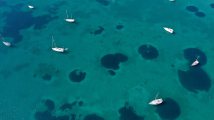 Fototapeta na wymiar Aerial drone bird's eye top view photo of traditional fishing boats in island of Mykonos, Cyclades, Greece