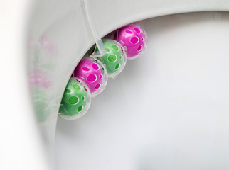 Multi-colored balls of toilet bowl cleaner. Selective focus, close-up.