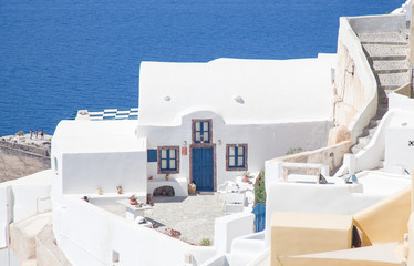 beautiful Oia town on Santorini island, Greece. Traditional white architecture and greek orthodox churches with blue domes over the Caldera, Aegean sea. Scenic travel background