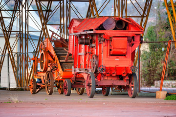 Fototapeta na wymiar Old agricultural machine, a rusty thresher