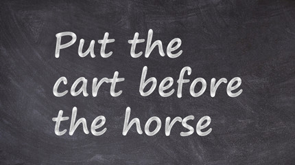 Put the cart before the horse written on blackboard © Guillaume