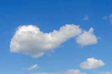 Naklejka na ściany i meble White cloud against blue sky. Background, texture
