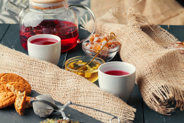 Cup of freshly brewed fruit and herbal tea, dark mood.Tea ceremony