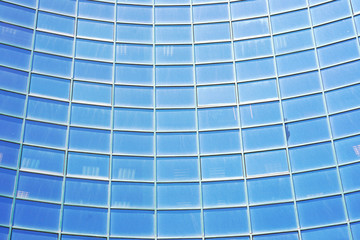 Glass blue square Windows of facade modern city business building skyscraper. Modern apartment buildings in new neighborhood. Windows of a building, texture.