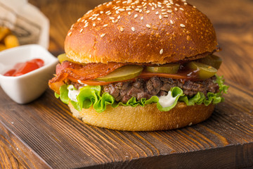 Burger with coarsely chopped meat, red sauce and potatoes