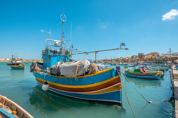 Fototapeta na wymiar Marsaxlokk, Malta - Colourful fishing boats in Marsaxlokk