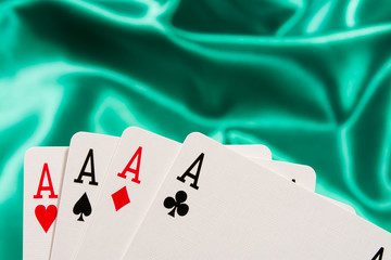 The combination of playing cards poker casino. Four aces on green background