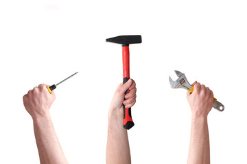 Three hands with screwdriver, hammer, and wrench on white background. Manual labor. Handmade and DYI. Building and repair