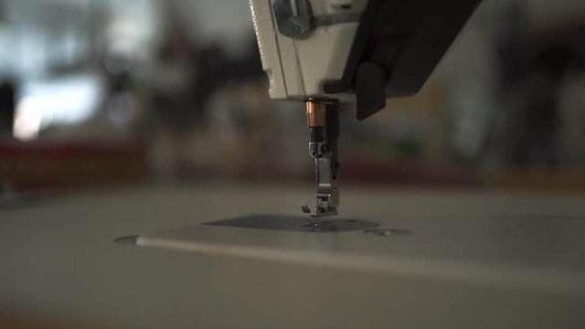 Sewing machine niddle close up with bokeh creamy background