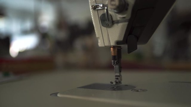 Sewing machine niddle close up with bokeh creamy background