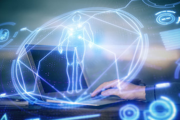 Science hologram with man working on computer on background. Concept of study. Double exposure.