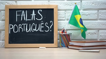 Do you speak Portuguese text on board, hand putting Brazil flag in box, language