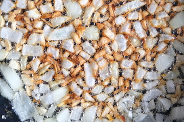 Onions and garlic being fried in a pan