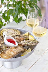 Fresh oysters with ice and white wine. Seafood. White background