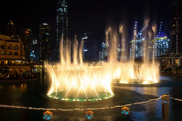 Dancing fountains in focus night background selective focus. Shallow depth of field.