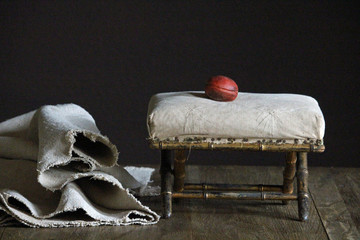 Obraz premium antique uphostered stool in living room