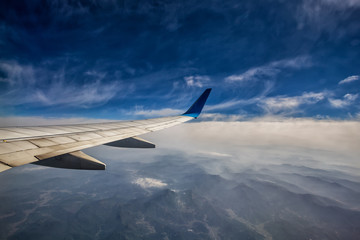 wingwing of an airplane flying above clouds of an airplane flying above clouds