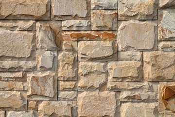 Background, texture, laying of natural stone and blocks of beige shades.