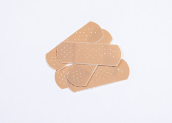 Set of adhesive plasters on white background. First aid and home help