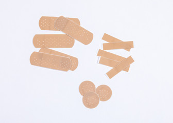 Set of adhesive plasters on white background. First aid and home help