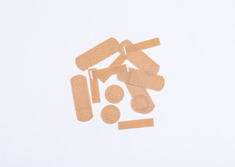 Set of adhesive plasters on white background. First aid and home help