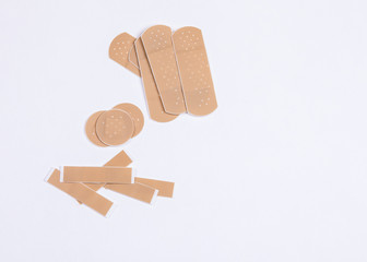 Set of adhesive plasters on white background. First aid and home help