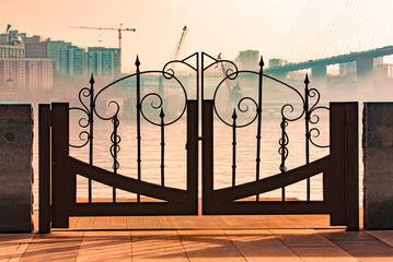 The a metal gate on the embankment of Vladivostok with views of the port and the bridge