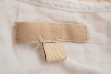 blank clothing label on fabric texture background