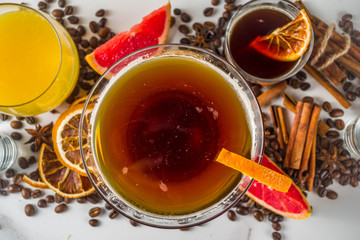 Negroni coffee cocktail with ingredients - coffee, orange, grapefruit, spices, liqueur, white marble background copy space
