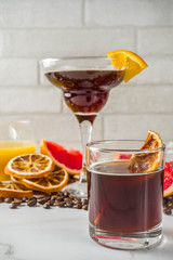 Negroni coffee cocktail with ingredients - coffee, orange, grapefruit, spices, liqueur, white marble background copy space