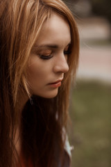 Portrait of a girl close-up with flying hair on the street