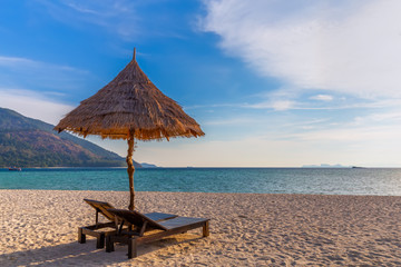 Beach chairs, umbrella and palms on the beautiful beach for holidays and relaxation at Koh Lipe island, Thailand