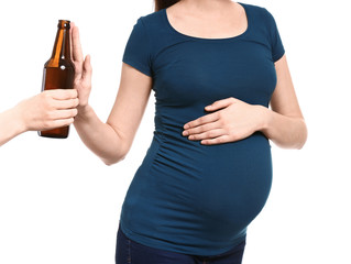 Pregnant woman rejecting bottle of beer on white background