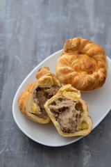 typical portuguese and brazilian chicken small pies on white dish