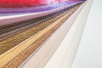 Fototapeta premium Catalog of multicolored imitation leather from matting fabric texture background, leatherette fabric texture. Industry background. 
