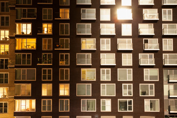 Modern apartment block transitioning from day to night