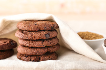 Tasty chocolate cookies on light table