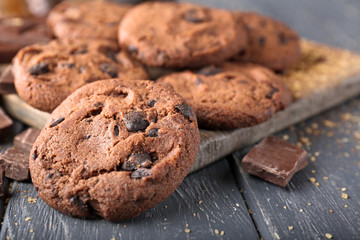 Tasty chocolate cookies on wooden background, closeup