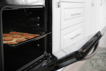 Tray with tasty cookies in oven