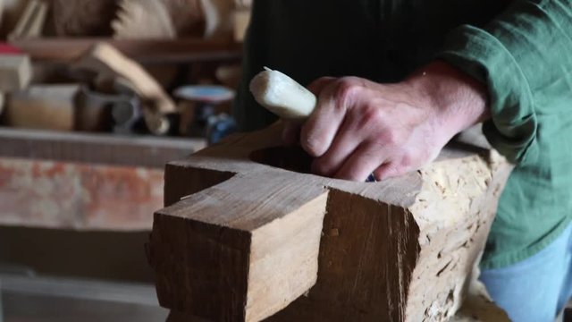 Craftsman making carving with chisel. 4K
