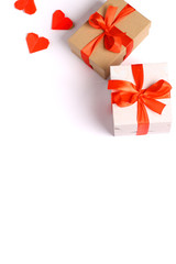 two cardboard gift boxes with a red ribbon bow isolated