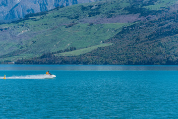 Fototapeta na wymiar Water bike on lake Wakatipu, Queenstown, New Zealand. Copy space for text.