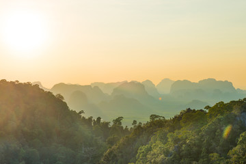 Beautiful tropical landscape with mountain rainforest and steep rocky ridge at horizon at sunset. Krabi, Thailand
